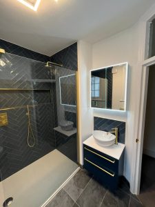bathroom with gold and blue features vanity and led mirror